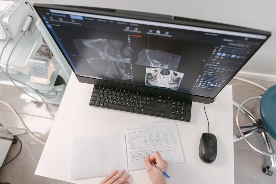 Radiologist analyzing X-ray scans on a computer monitor while taking notes. Medical documents visible.